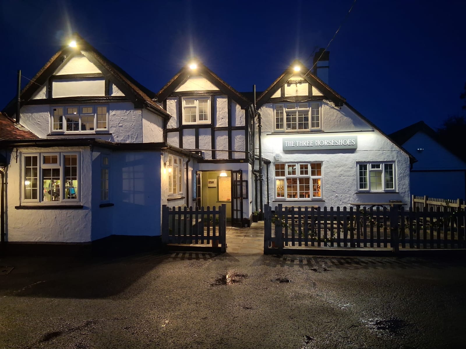The Three Horseshoes pub exterior at dusk